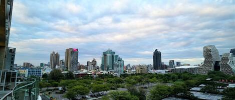 A cityscape with modern buildings, a mix of high-rise and low-rise structures, and a clear sky.