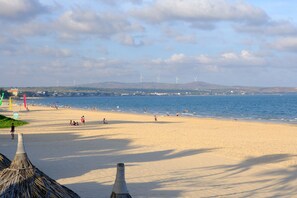 Private beach, white sand, sun loungers, beach umbrellas