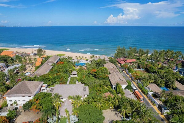 A coastal residential area with houses, a beach, and a clear blue sky. - Allezboo Beach Resort & Spa (Mui Ne)