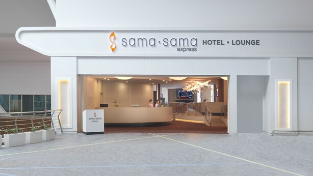 A modern hotel lobby with a reception desk, seating area, and a bar. - Sama-Sama Express KLIA Terminal 2 - Airside Transit Hotel (Sepang)