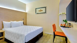 A hotel room with a bed, a desk with a chair, a television, and a framed picture on the wall. - Sama-Sama Express KLIA Terminal 2 - Airside Transit Hotel (Sepang)