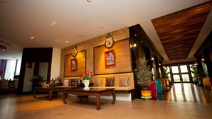 A lobby with a reception desk, seating area, and decorative wall panels. - Siam Paradise Entertainment Complex (Bangkok)