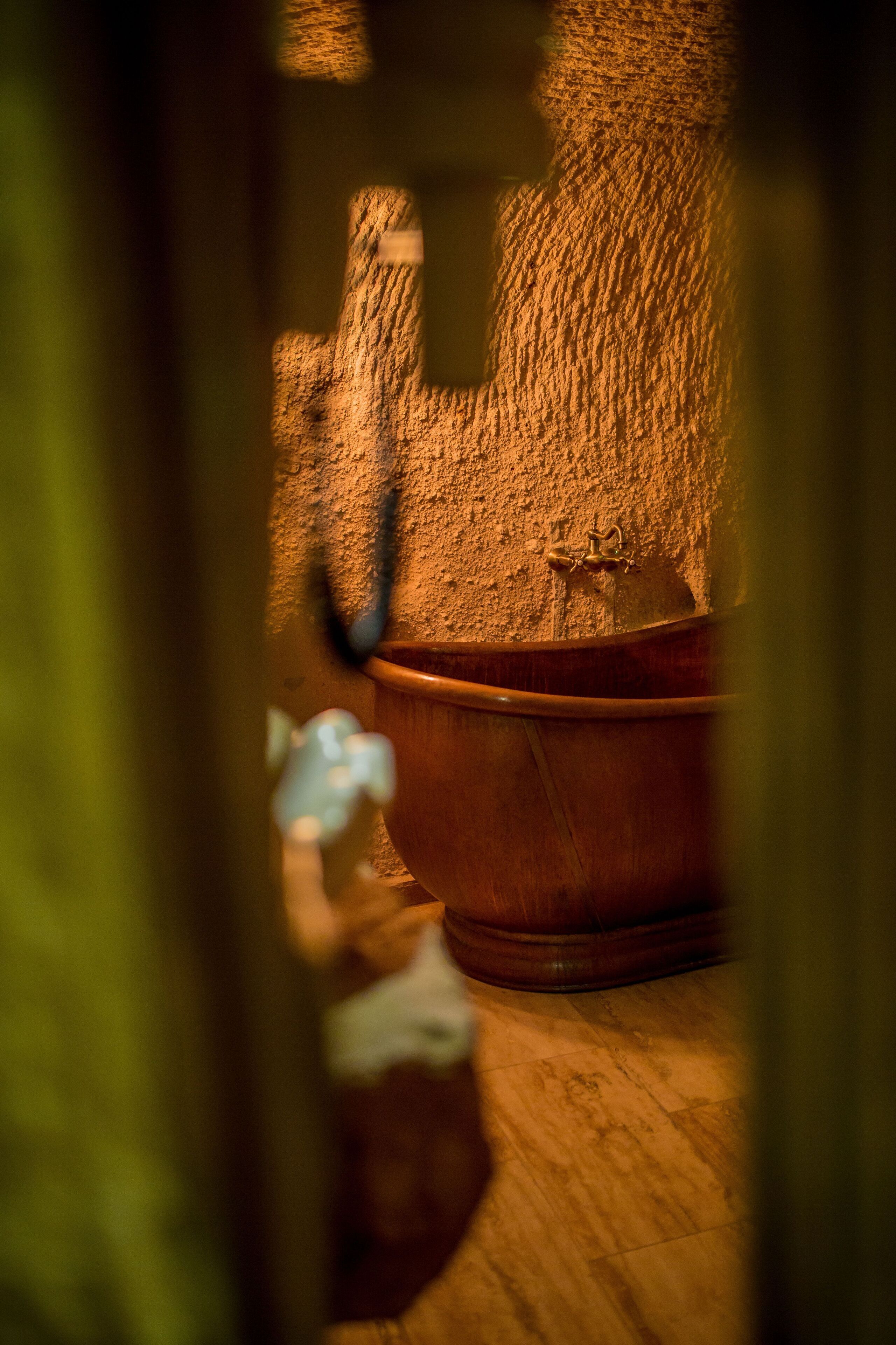 premier cave suite | bathroom | shower, hair dryer, slippers, towels