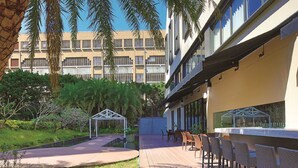 A courtyard with a bar area, outdoor seating, and a pool. - Wo (Kaohsiung)