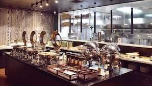 A buffet setup with various food containers and serving utensils. - Wo (Kaohsiung)