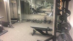 A gym with various exercise equipment, including treadmills, weight machines, and free weights. - Yarnfield Park Training Centre (Stone)