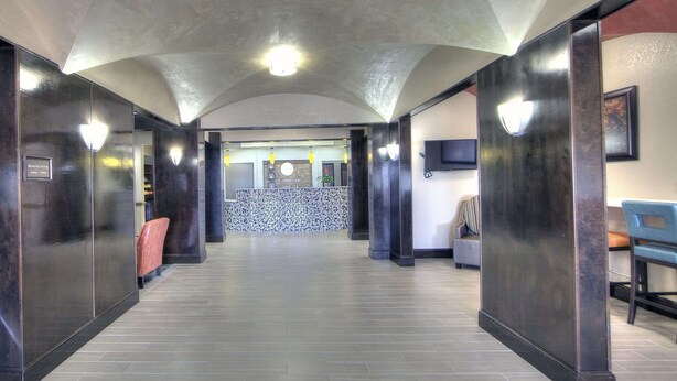 A hotel lobby with a reception desk, seating area, and a television. - Comfort Inn & Suites Fort Worth West I-30 NAS JRB (Fort Worth)