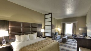 A hotel room with a large bed, a desk, a chair, a TV, and a window with curtains. - Comfort Inn & Suites Fort Worth West I-30 NAS JRB (Fort Worth)