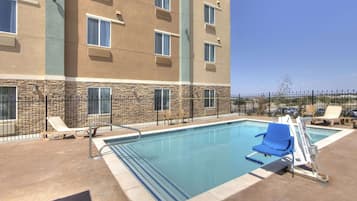 Seasonal outdoor pool, open 10:00 AM to 10:00 PM, pool umbrellas