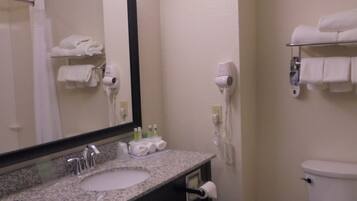A bathroom with a sink, mirror, towel rack, and toilet.
