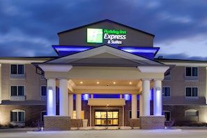 A Holiday Inn Express & Suites building with a prominent sign, a covered entrance, and a brick facade. - Holiday Inn Express & Suites Nevada by IHG (Nevada)