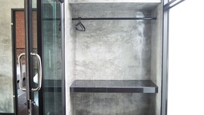 A modern interior with a glass door, concrete walls, and a metal handle. - Needa Rock Resort (Khanom)