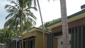 A modern building with a flat roof and a large open area in front. - Needa Rock Resort (Khanom)
