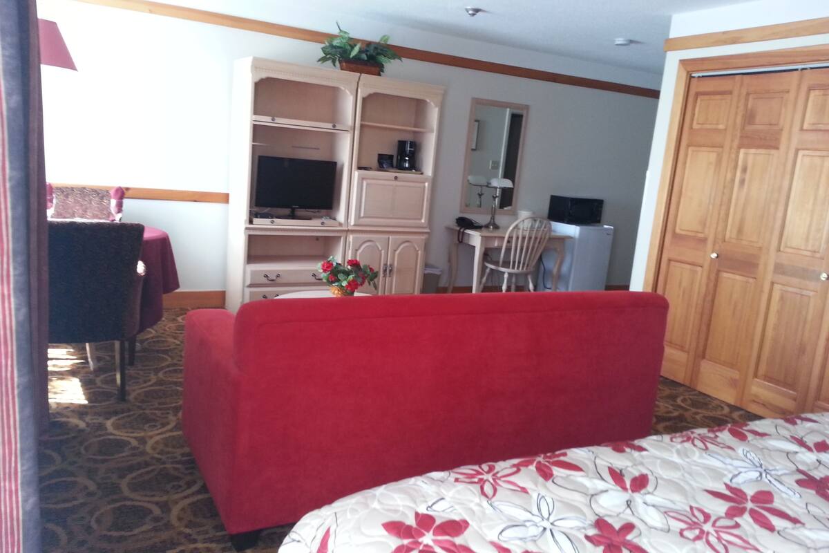 suite, 1 king bed with sofa bed | living area | 32-inch tv with cable channels