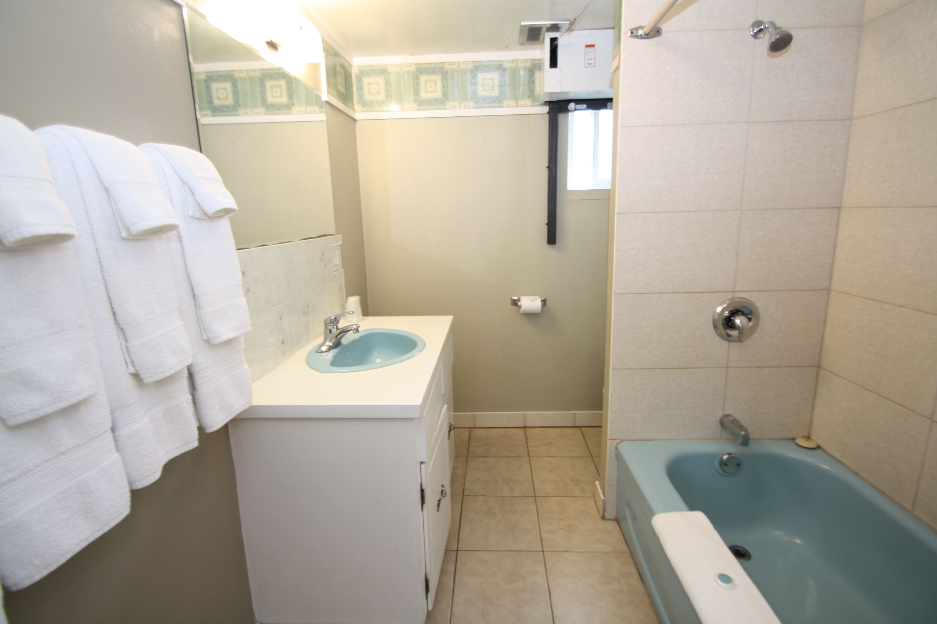 A bathroom with a sink, a bathtub, and a shower.