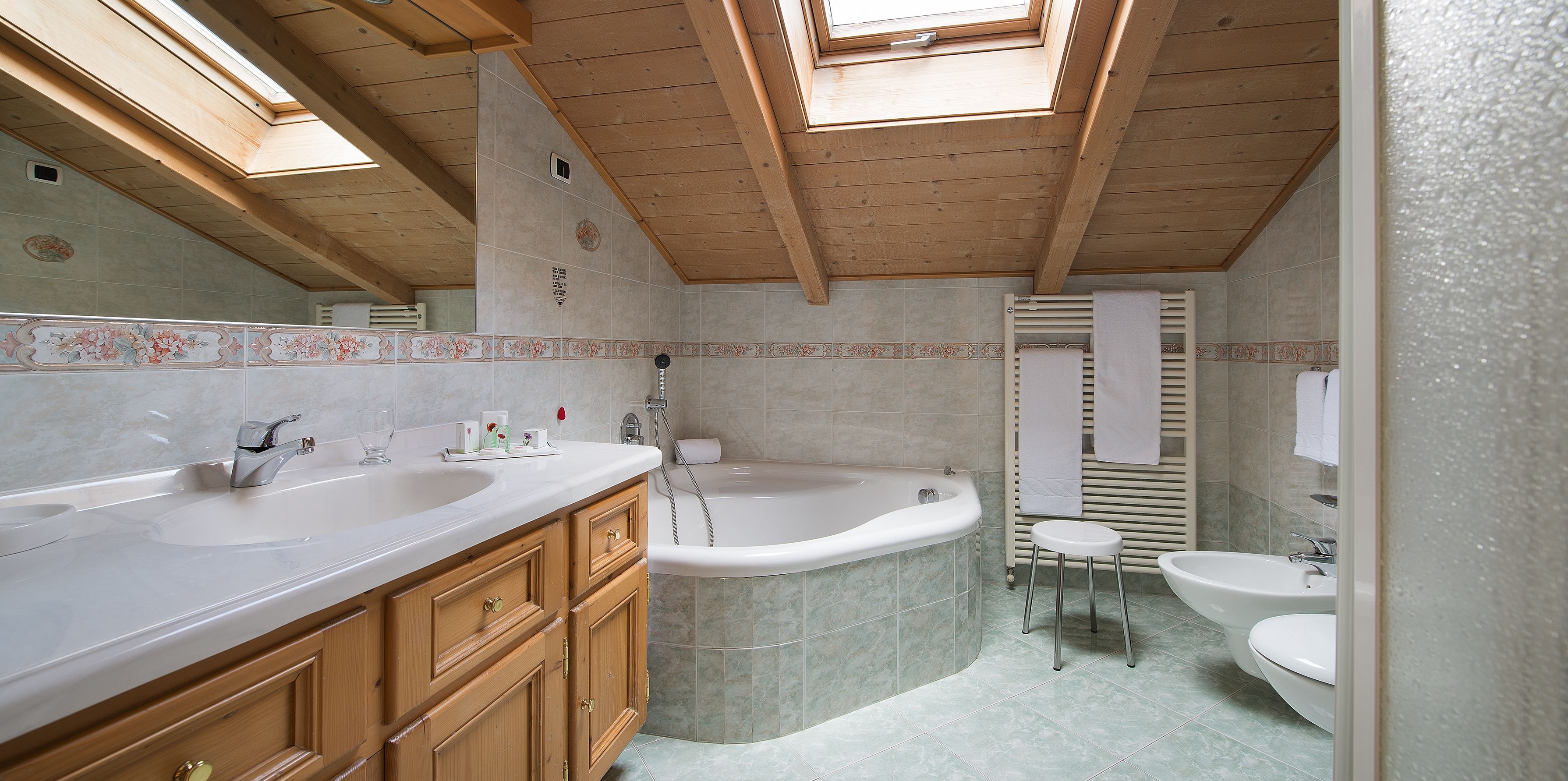 A bathroom with two sinks, a bathtub, and a shower.