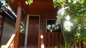 A traditional wooden entrance with a tiled floor and a decorative door. - Bird Bungalow (Ko Pha-ngan)