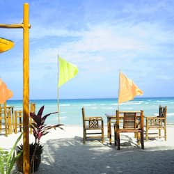 On the beach, white sand, sun-loungers, beach umbrellas