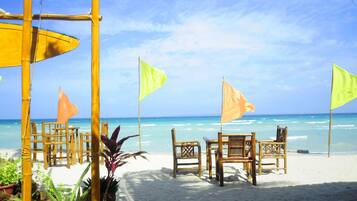 On the beach, white sand, sun loungers, beach umbrellas