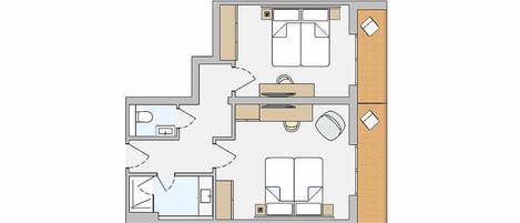 Plano de un hotel que muestra un baño, una kitchenette, una sala de estar con sofá y mesa de comedor, y un balcón pequeño.