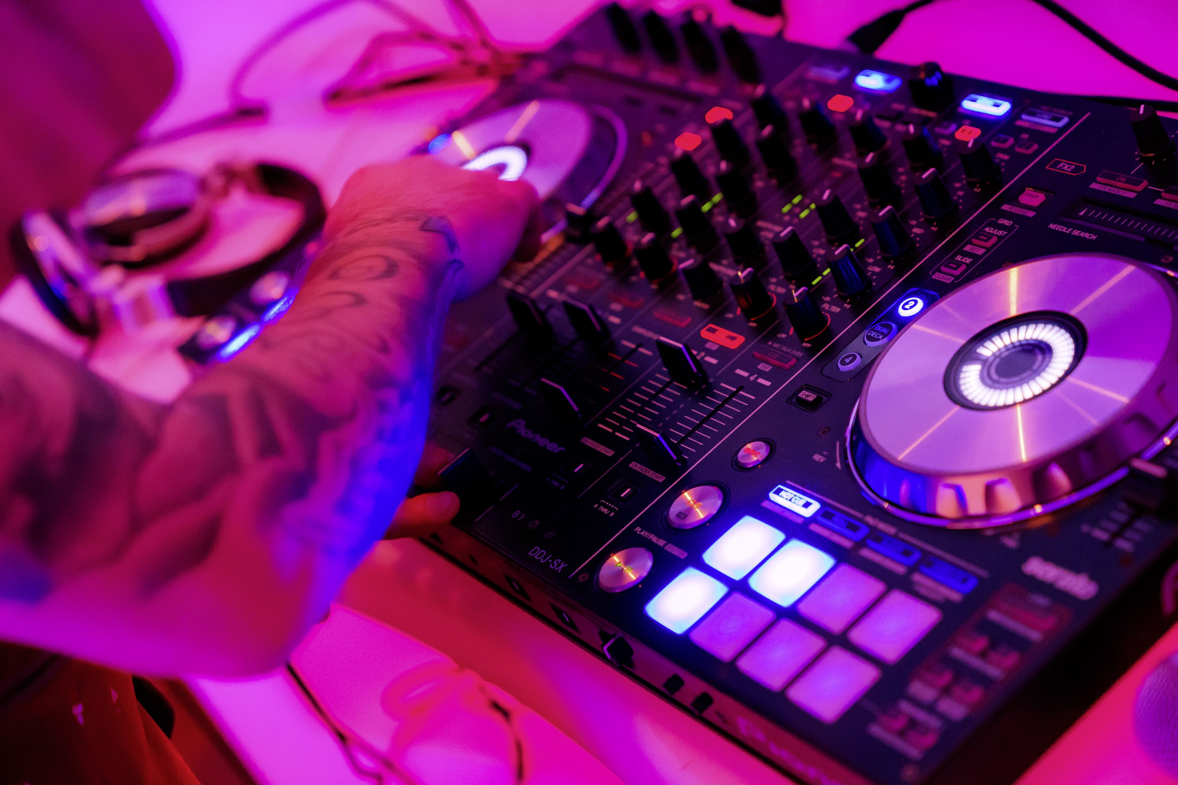 A DJ mixer with various controls and a CD player.