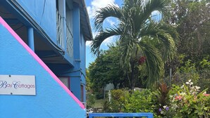 A blue building with a sign reading "Bay Cottages". - Ellen Bay Cottages (Seatons Village)