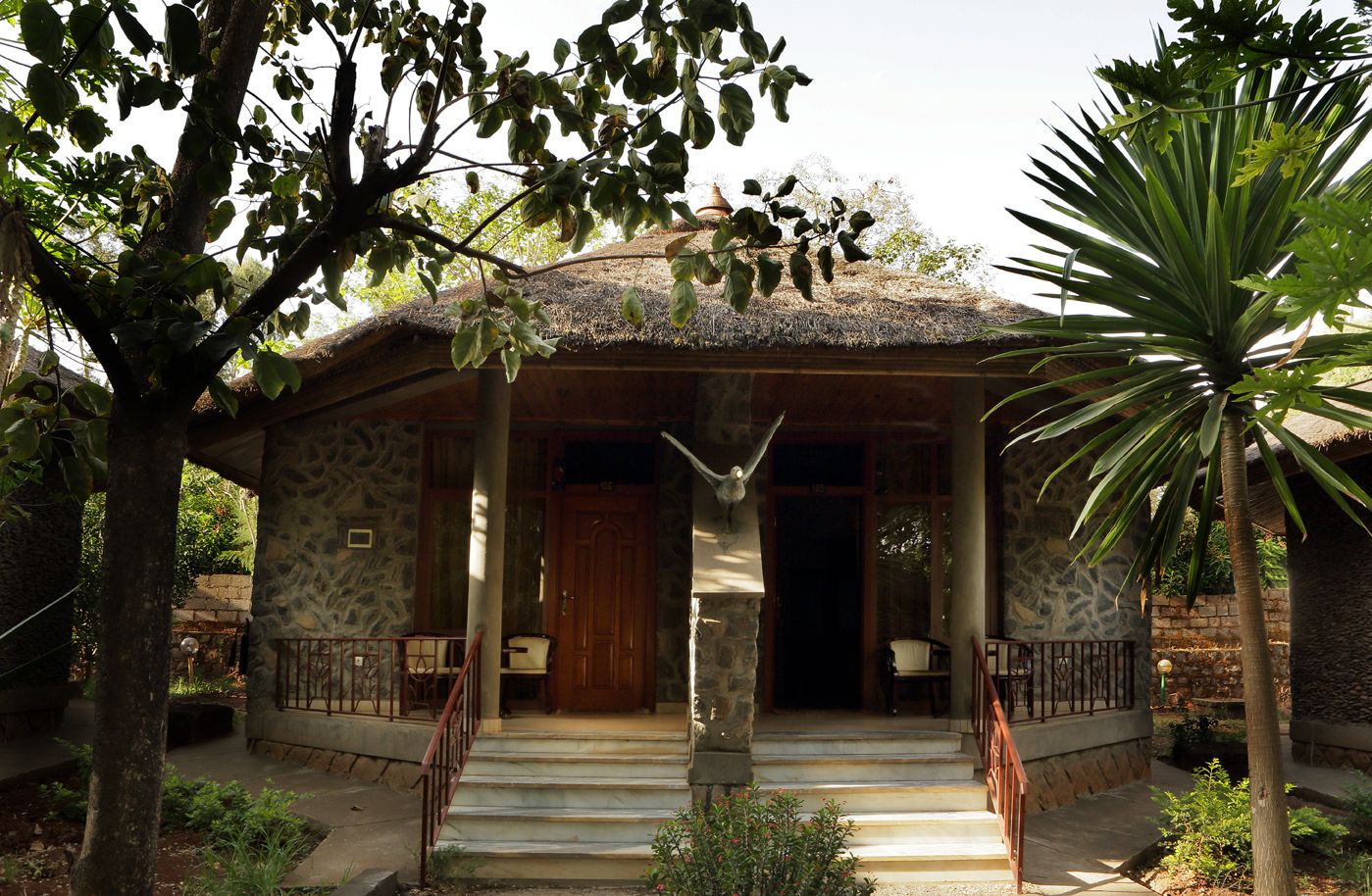 A stone building with a wooden door and a staircase leading to the entrance.