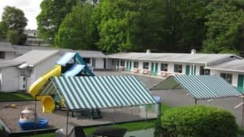 Guests can enjoy a fun stay with a playground featuring a slide and play structure.