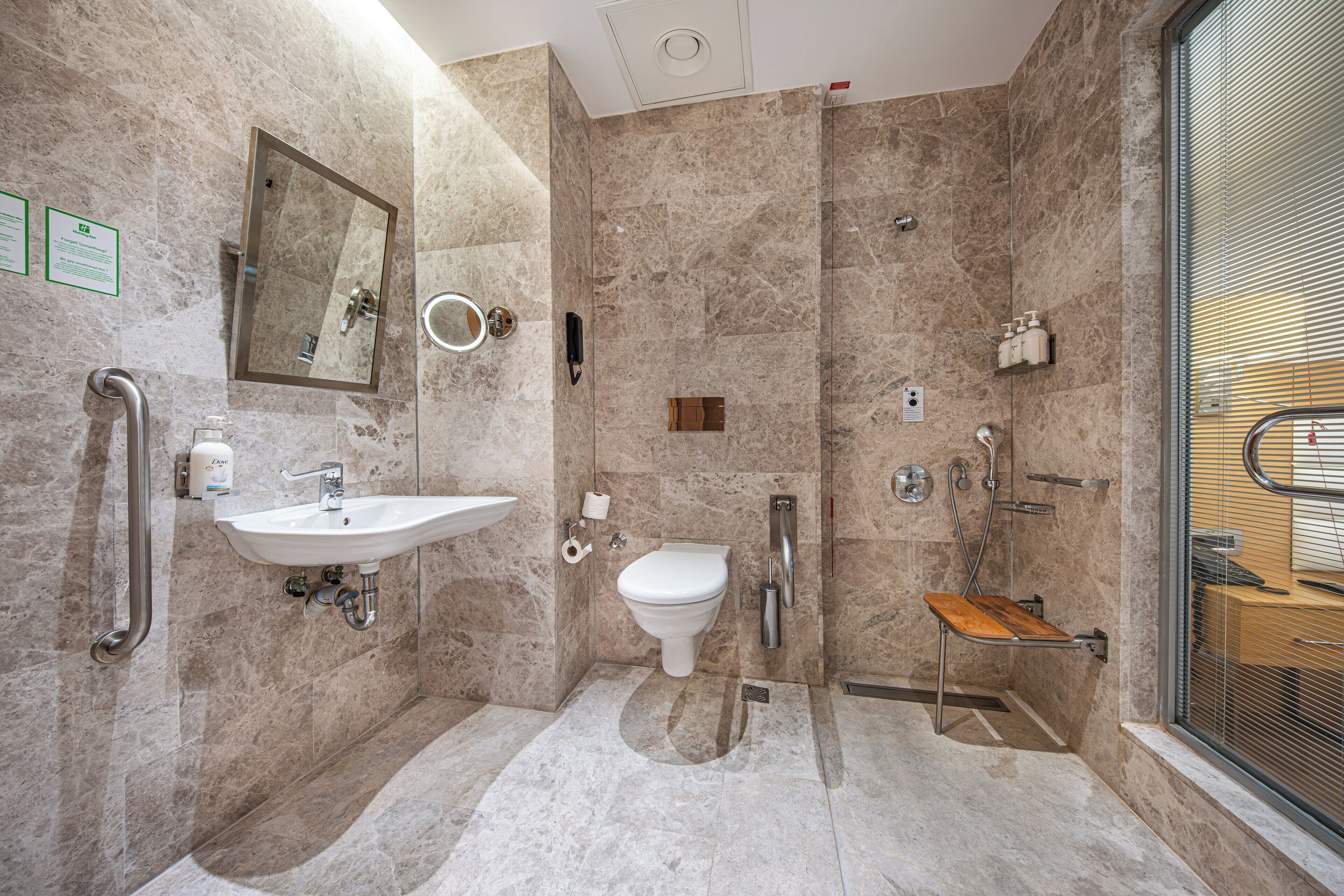 A modern bathroom with a sink, toilet, and shower.
