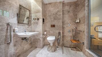 A modern bathroom with a sink, toilet, and shower.