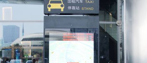 A taxi stand sign with a map and QR code.