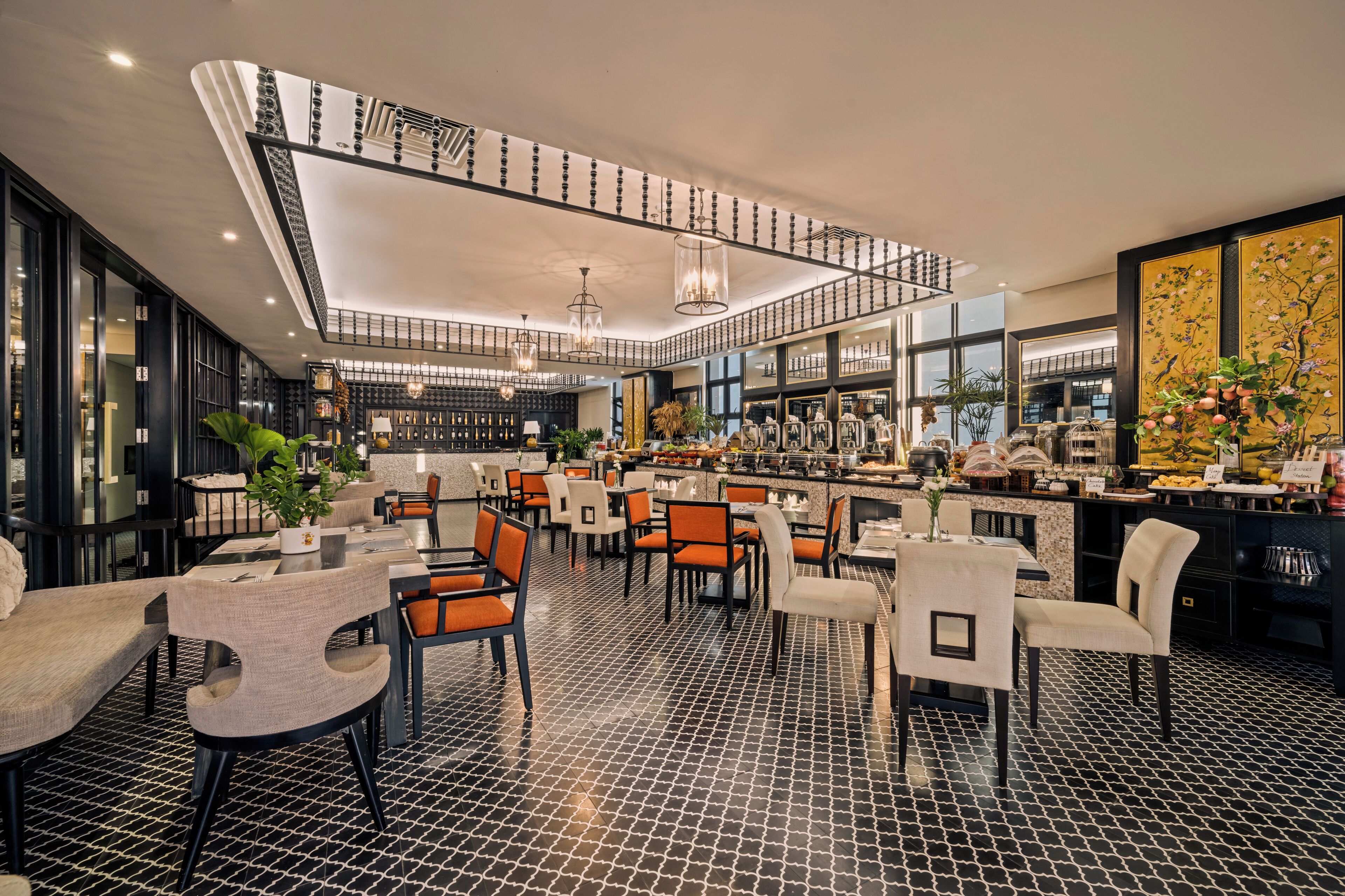 A modern restaurant with a black and white tiled floor, multiple dining tables with chairs, and a central bar area.