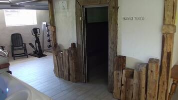 Relax in a serene space with a Turkish bath area, exercise equipment, and a cozy reading nook.