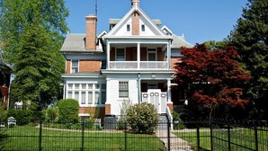A two-story Victorian-style house with a prominent gabled roof, a front porch, and a brick chimney. - The Albanus Phillips Inn (Cambridge)