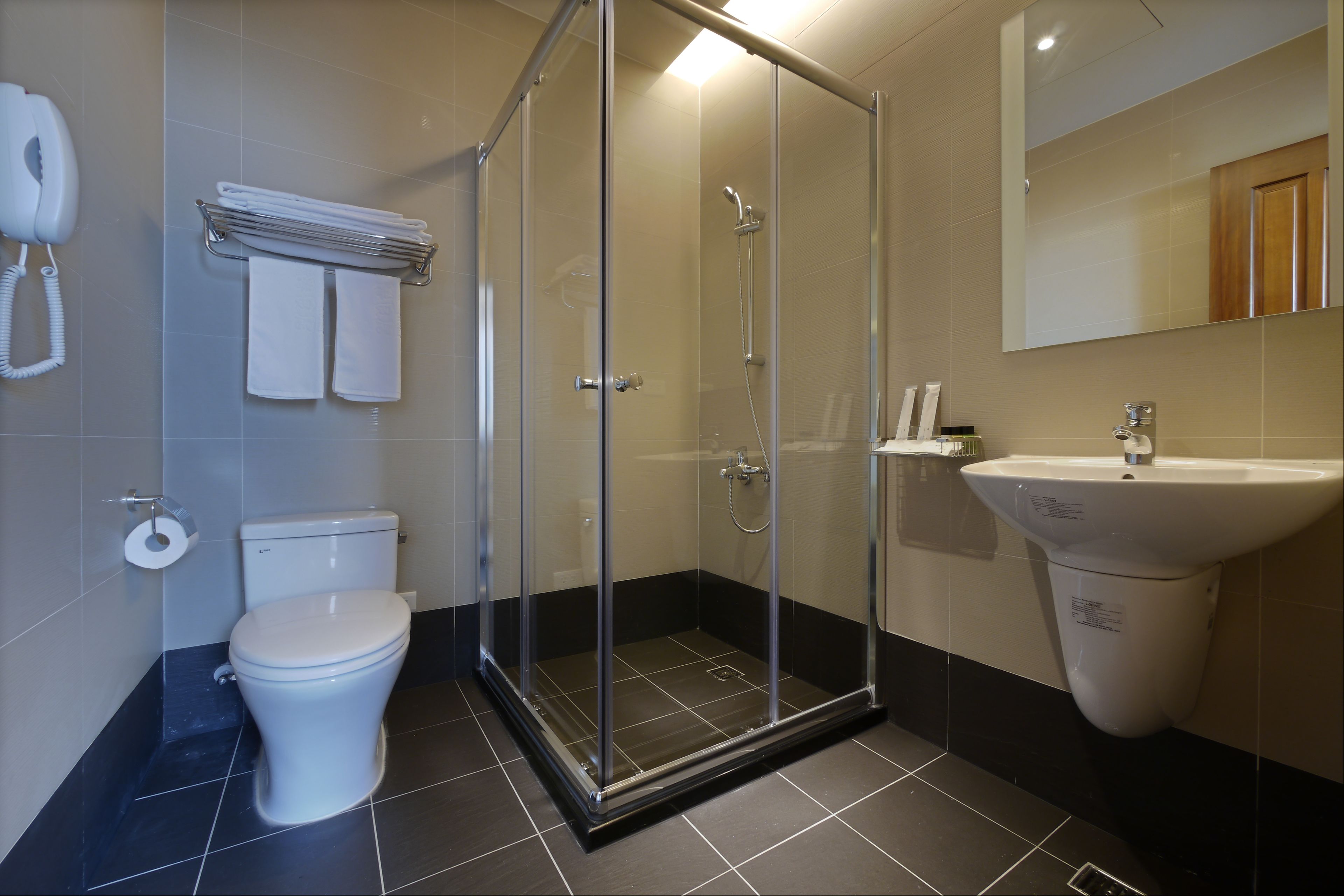 shower, hair dryer, towels, shampoo