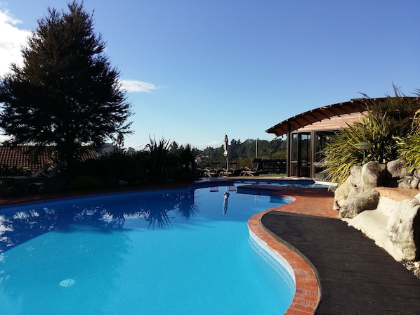 Indoor pool, outdoor pool, open 8 AM to 8 PM, pool umbrellas