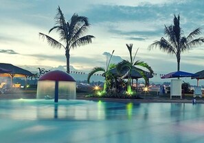 A pool area with palm trees, a gazebo, and a water slide. - Danao Coco Palms Resort (Danao City)