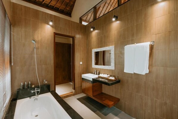 A modern bathroom with a large bathtub, a wooden vanity, and a mirror above the sink. - The Sakara Ubud Villas (Tegallalang)