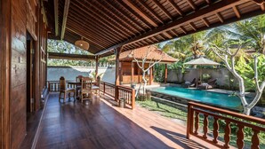 A wooden deck with a pool, outdoor furniture, and a view of the pool area. - The Sakara Ubud Villas (Tegallalang)