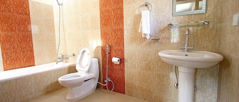 A bathroom with a toilet, sink, and shower.