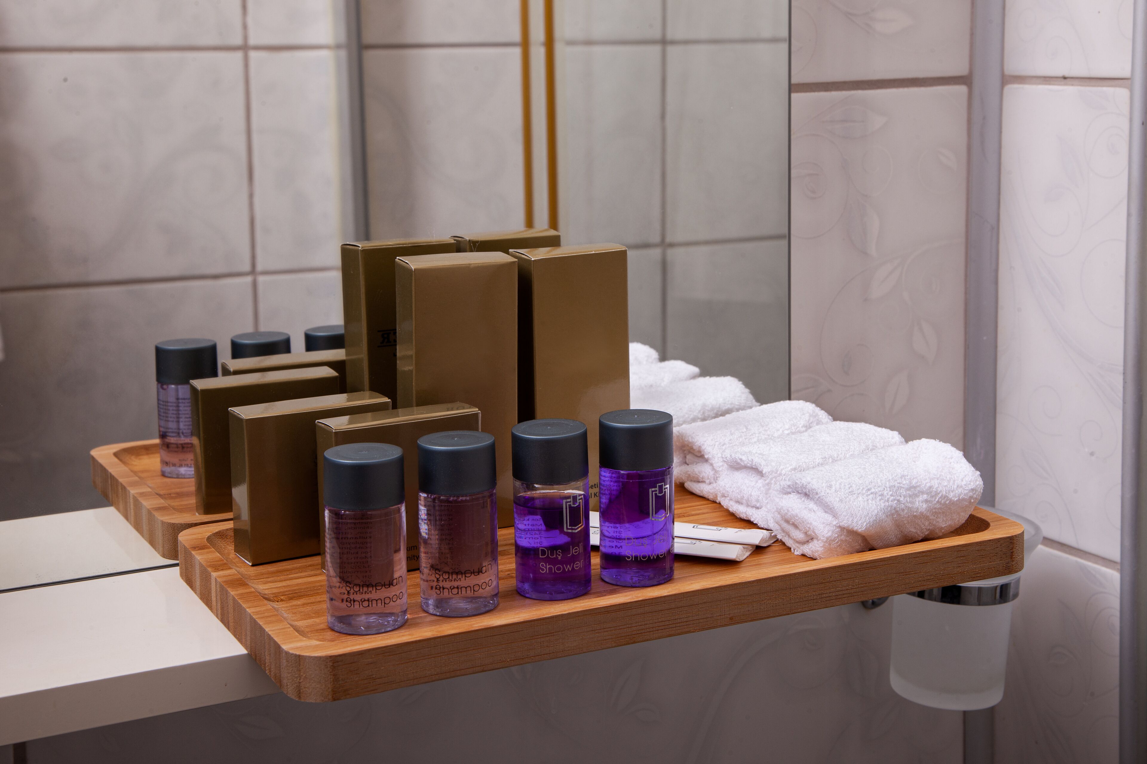 deluxe double room with brick wall | bathroom | shower, free toiletries, hair dryer, slippers