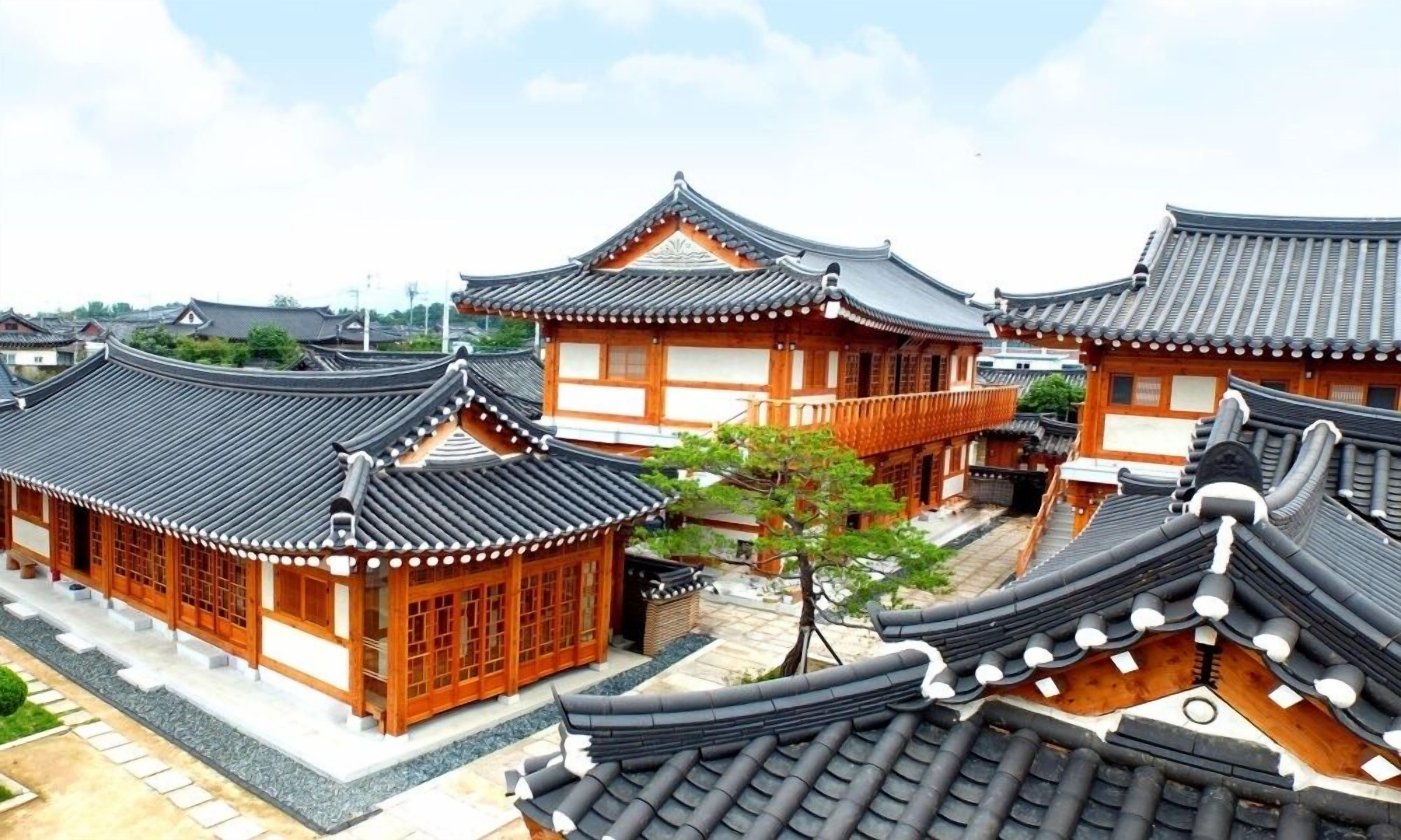 A traditional Korean-style building with curved tiled roofs and wooden structures.