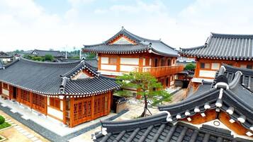 A traditional Korean-style building with curved tiled roofs and wooden structures.