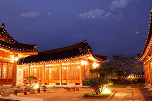 A traditional Japanese building with wooden architecture and illuminated windows at night. - Gyeongju Hwangnamkwan Hanok Hotel (Gyeongju)