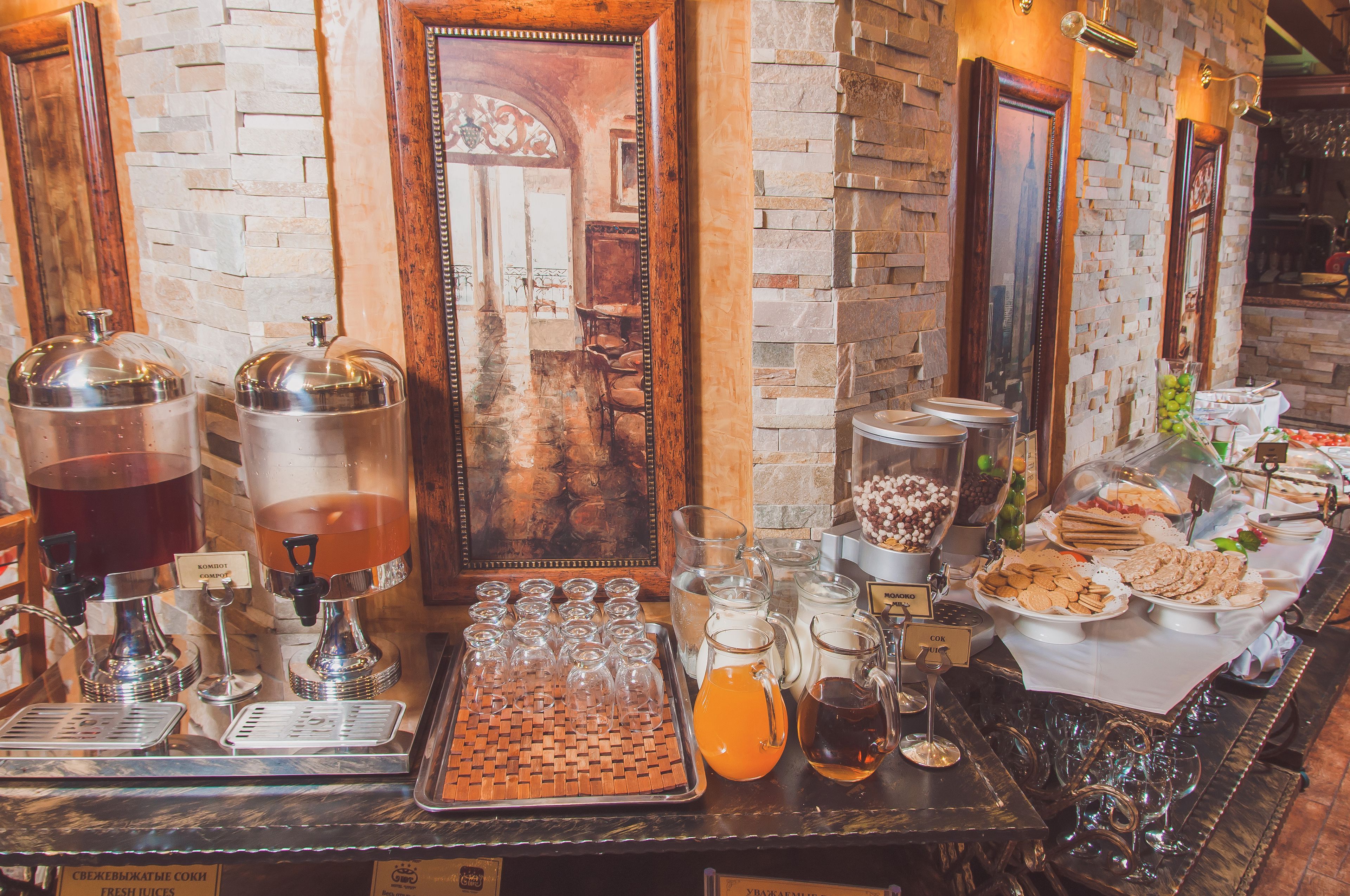 A buffet setup with various food items and beverages.