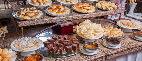 A buffet with various food items and condiments.