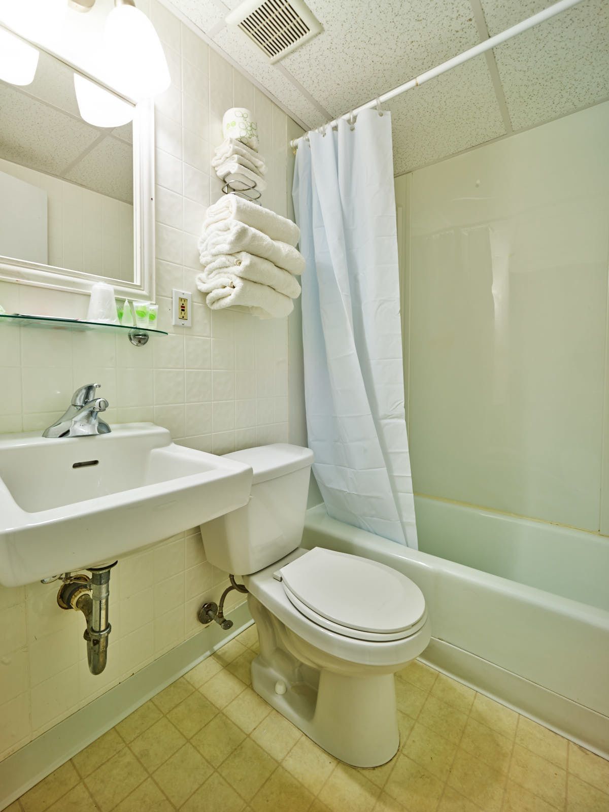 A bathroom with a sink, toilet, and shower.