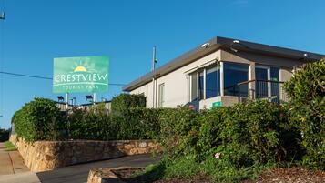 A modern building with a sign for Crestview Tourist Park.
