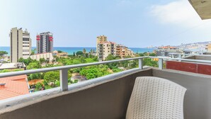 A balcony with a view of a coastal cityscape, including buildings and the sea. - Al Murjan Palace Hotel (Jounieh)