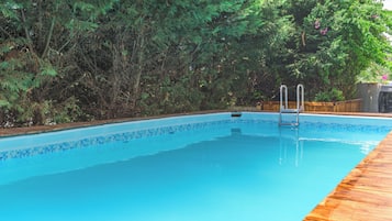Seasonal outdoor pool, pool umbrellas, pool loungers